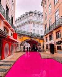 Pink Street at night with crowds and illuminated bars